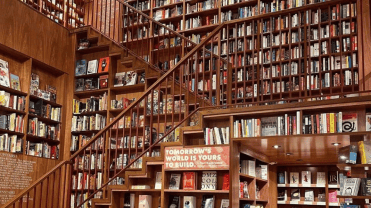 Photograph inside a large two story bookstore filled from floor to ceiling with books.