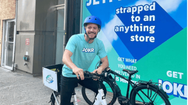 Photograph of a person making quick-delivery grocery deliveries.
