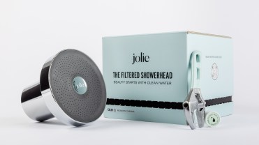 Jolie filtered showerhead on a white background next to a mint green box.