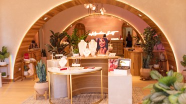The new store format features a warmer color palette and repetitive arches that allows the company to display products more seamlessly in the store.