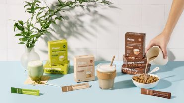 Three of Blume's products on a blue counter.